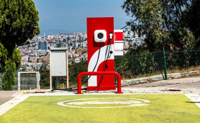 Electric vehicle charging station in Turkey in front of cityscape