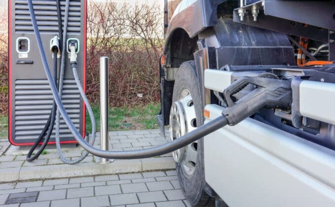 Electric lorry charges its battery at a charging station