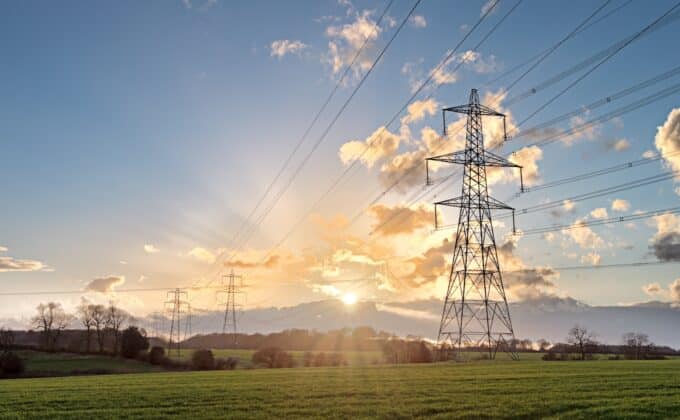 Electricity Pylon - UK standard overhead power line transmission tower at sunset.